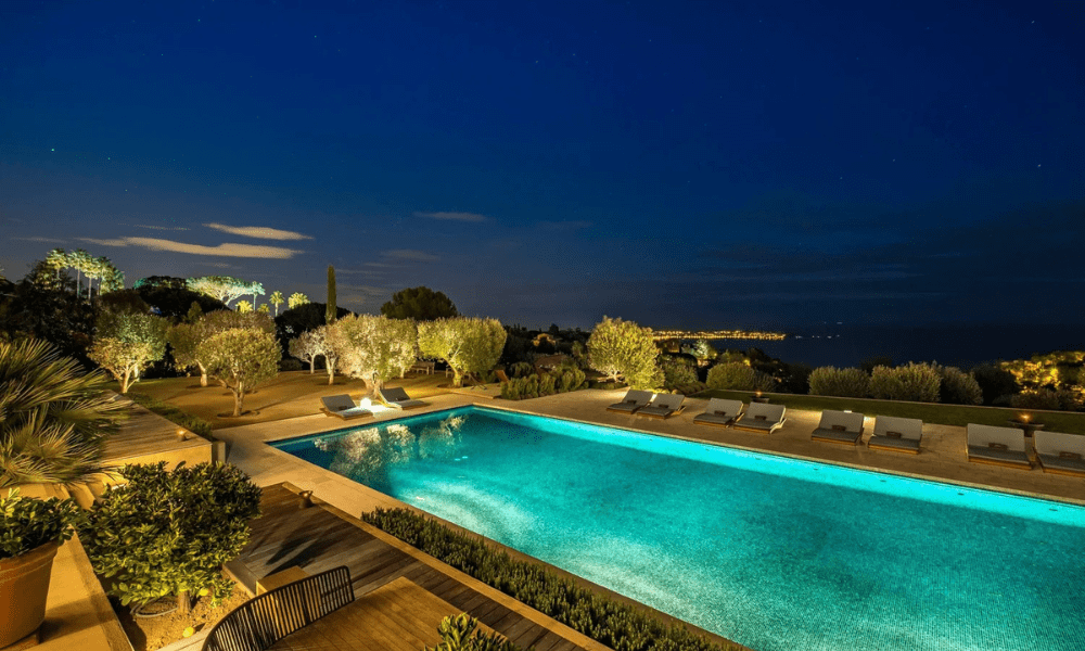 Wide-angle exterior shot capturing villa façade and surrounding greenery